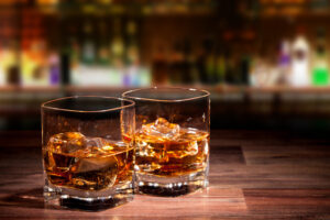 Two glasses of drinks on bar table.